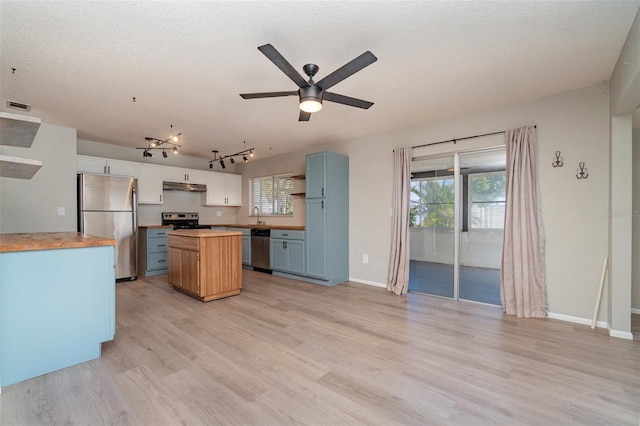 8238 San Jacinto Ave, North Port, FL 34287 - kitchen featuring light wood-style flooring, visible vents, a kitchen island, wooden counters, and appliances with stainless steel finishes