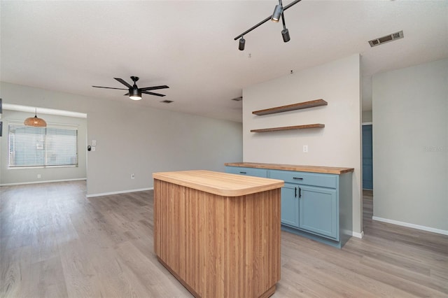8238 San Jacinto Ave, North Port, FL 34287 - kitchen featuring open shelves, visible vents, blue cabinets, light wood-type flooring, and wood counters