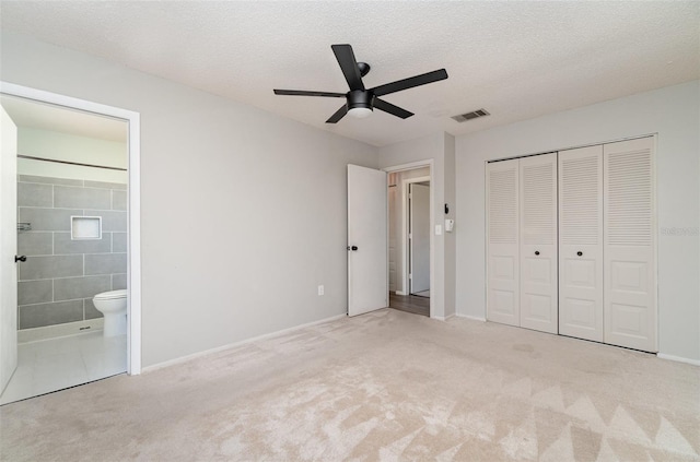 8238 San Jacinto Ave, North Port, FL 34287 - unfurnished bedroom featuring visible vents, connected bathroom, carpet floors, a closet, and a textured ceiling