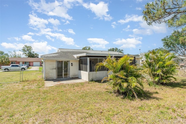 8238 San Jacinto Ave, North Port, FL 34287 - back of property featuring a sunroom, stucco siding, and a lawn