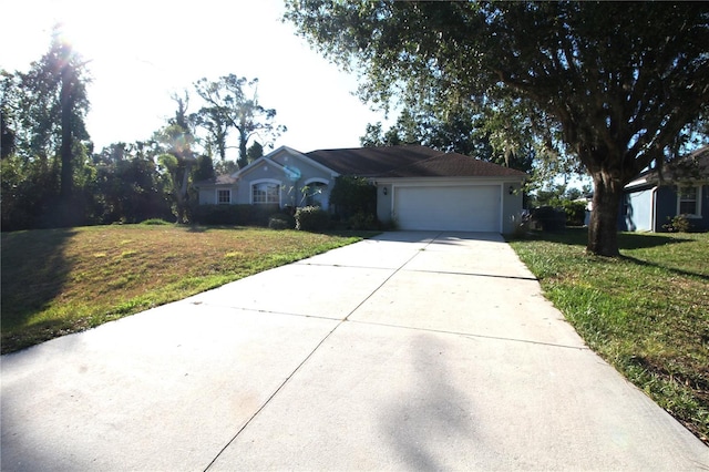 4749 Oakley Rd, North Port, FL 34288 - ranch-style home featuring a garage, a front yard, driveway, and stucco siding