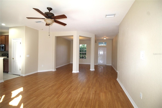 4749 Oakley Rd, North Port, FL 34288 - unfurnished living room with light wood finished floors, visible vents, and ceiling fan