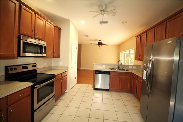 4749 Oakley Rd, North Port, FL 34288 - kitchen featuring light tile patterned floors, a sink, light countertops, appliances with stainless steel finishes, and a ceiling fan