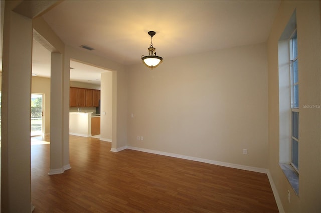 4749 Oakley Rd, North Port, FL 34288 - spare room with wood finished floors, baseboards, and visible vents