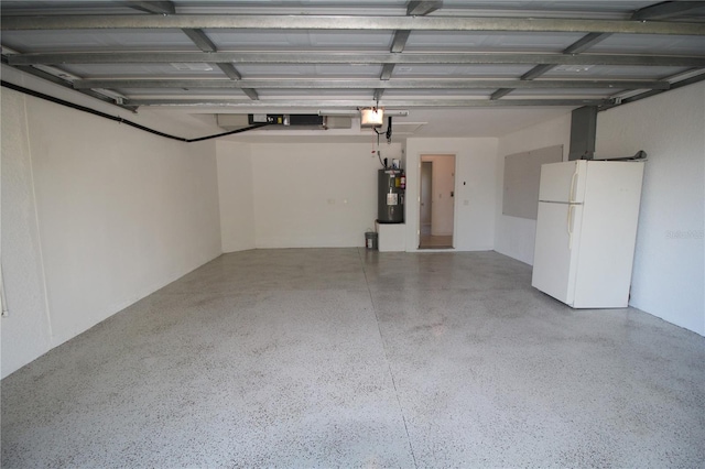 4749 Oakley Rd, North Port, FL 34288 - garage featuring electric water heater, a garage door opener, and freestanding refrigerator