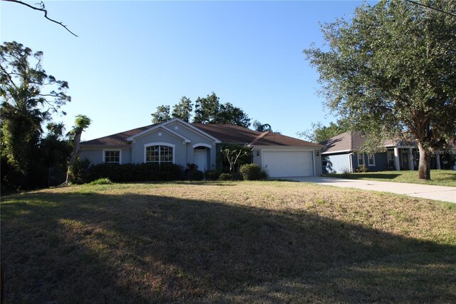 4749 Oakley Rd, North Port, FL 34288 - ranch-style house featuring stucco siding, driveway, a garage, and a front lawn