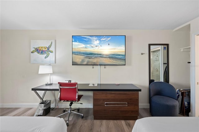 7150 N Tamiami Trl Unit S-600, Sarasota, FL 34243 - bedroom featuring baseboards and wood finished floors