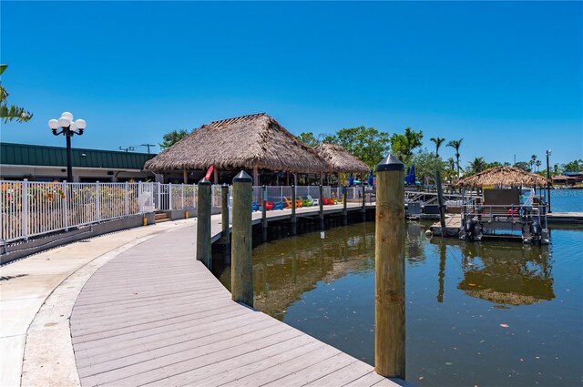 7150 N Tamiami Trl Unit S-600, Sarasota, FL 34243 - dock area featuring a gazebo, a water view, and fence