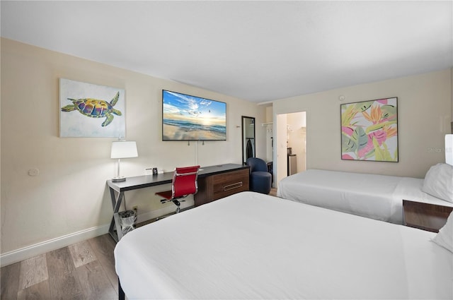 7150 N Tamiami Trl Unit S-600, Sarasota, FL 34243 - bedroom with baseboards, wood finished floors, and ensuite bathroom