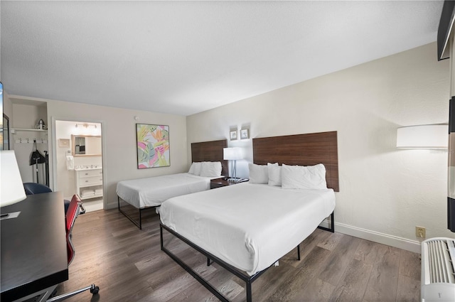 7150 N Tamiami Trl Unit S-600, Sarasota, FL 34243 - bedroom featuring wood finished floors, baseboards, and connected bathroom