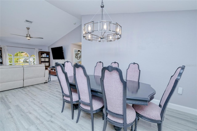 dining room with wood finished floors, ceiling fan with notable chandelier, baseboards, lofted ceiling, and visible vents