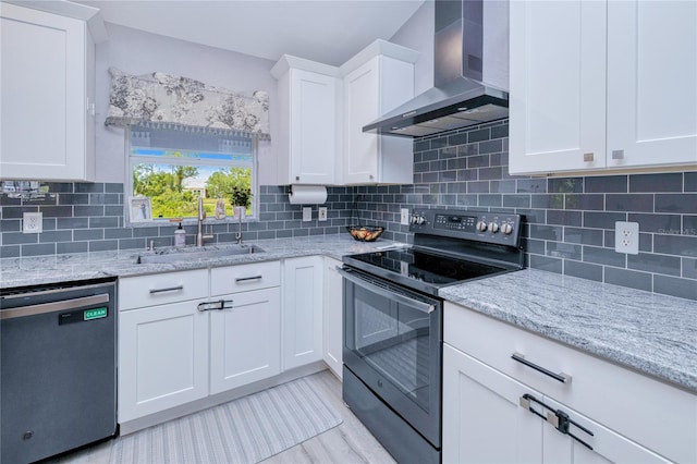 kitchen featuring a sink, backsplash, wall chimney range hood, black electric range, and dishwasher