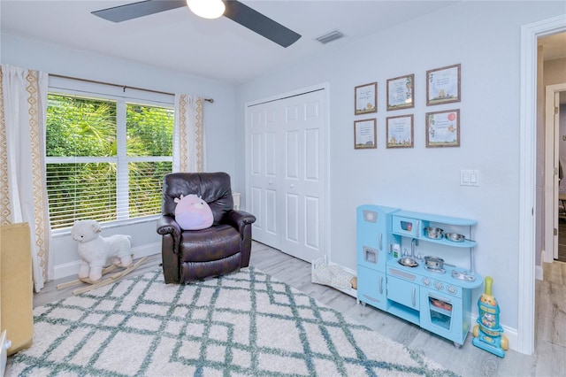 sitting room featuring wood finished floors, visible vents, ceiling fan, and baseboards