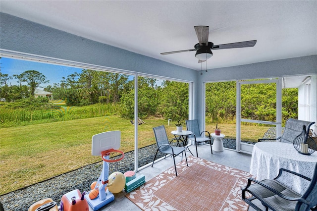 sunroom featuring a ceiling fan