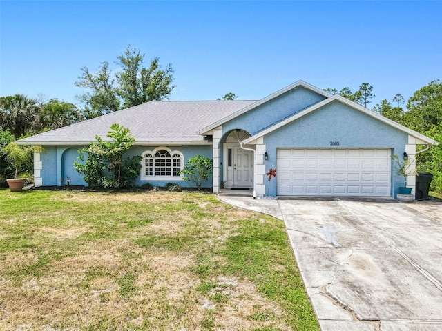 ranch-style house with stucco siding, driveway, a front yard, and a garage