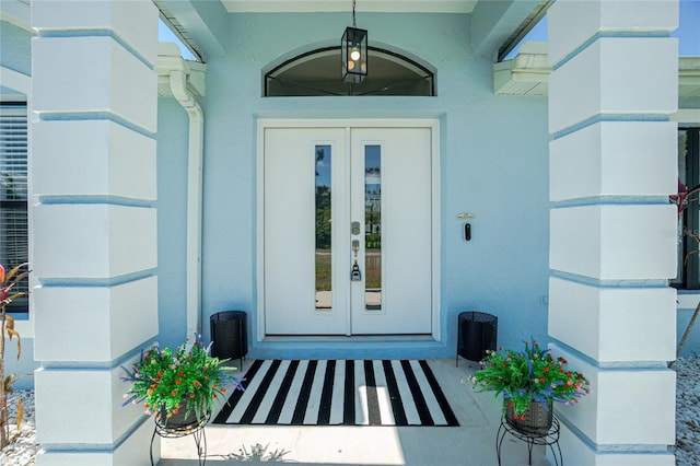 doorway to property with french doors and stucco siding