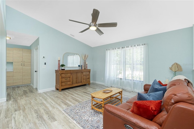 living area featuring wood finished floors, ceiling fan, baseboards, and lofted ceiling