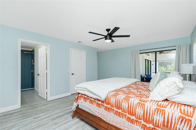 bedroom featuring ceiling fan, visible vents, baseboards, and wood finished floors