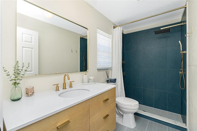 full bath with toilet, tiled shower, vanity, and tile patterned flooring