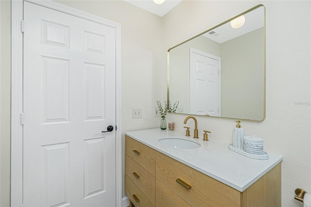 bathroom featuring vanity and visible vents