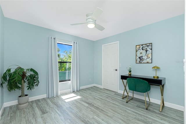 interior space featuring baseboards, ceiling fan, and wood finished floors