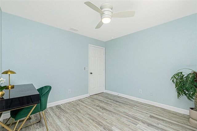 office area featuring ceiling fan, visible vents, baseboards, and wood finished floors