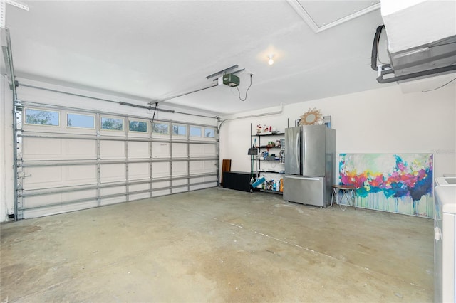 garage featuring a garage door opener and freestanding refrigerator