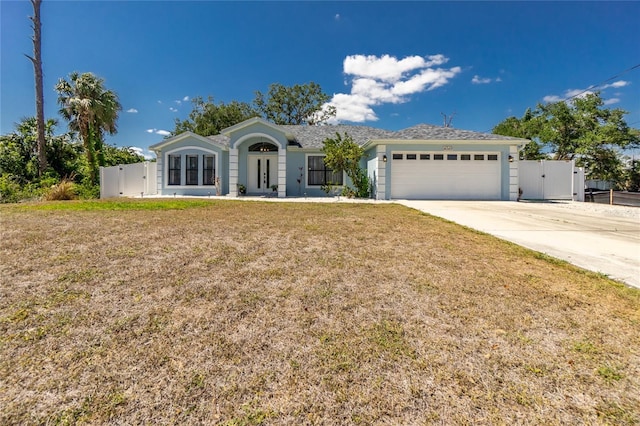 single story home with concrete driveway, a front lawn, a gate, and an attached garage