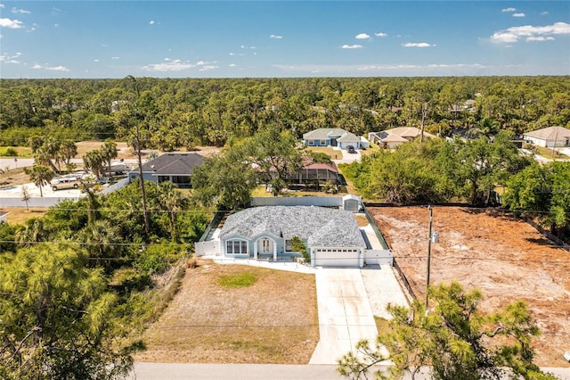 bird's eye view featuring a wooded view and a residential view