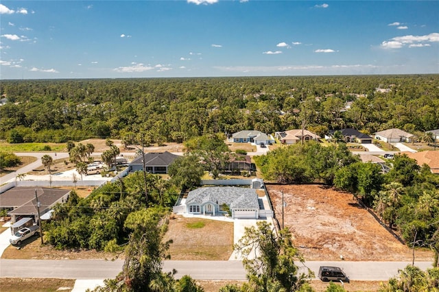 birds eye view of property with a wooded view and a residential view