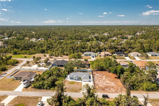 aerial view featuring a forest view and a residential view
