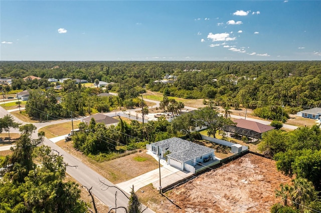 bird's eye view featuring a wooded view