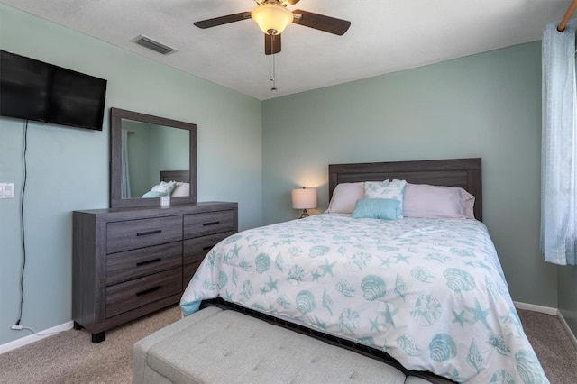 bedroom featuring baseboards, a ceiling fan, visible vents, and carpet floors
