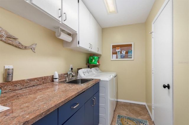 laundry room with baseboards, a sink, washer and clothes dryer, and cabinet space