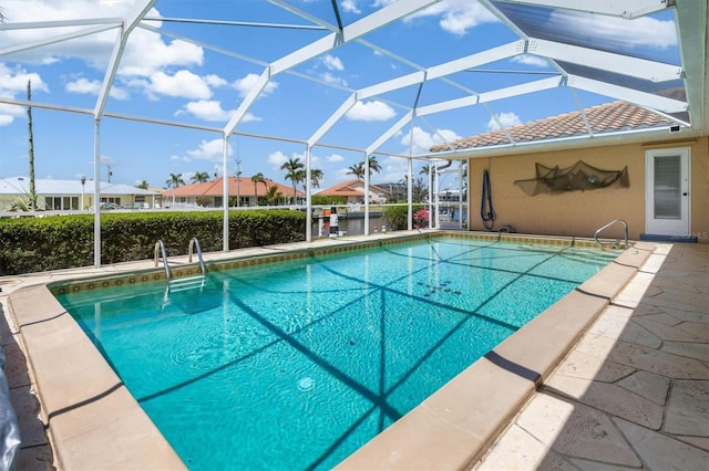 pool with a residential view, a patio area, and a lanai