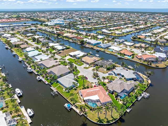 drone / aerial view with a residential view and a water view