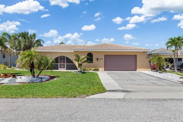 view of front facade featuring a front lawn, a tiled roof, concrete driveway, an attached garage, and stucco siding