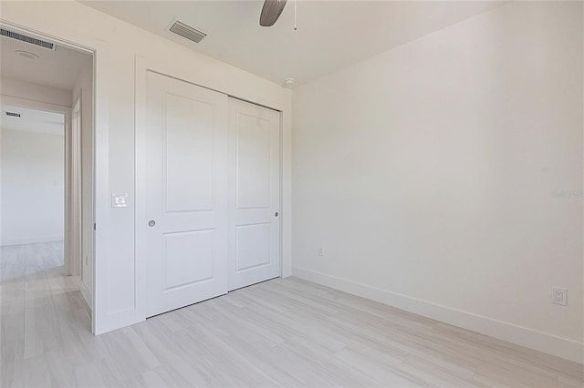 unfurnished bedroom featuring a closet, visible vents, and baseboards