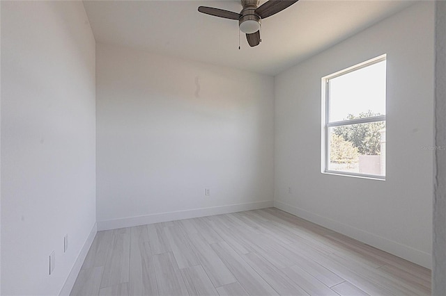 unfurnished room with baseboards, ceiling fan, and light wood finished floors