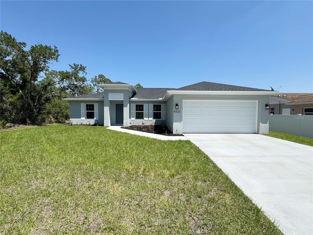 4336 Blackman St, North Port, FL 34291 - view of front facade with a garage, driveway, a front lawn, and stucco siding