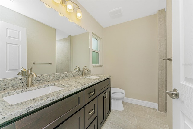 4336 Blackman St, North Port, FL 34291 - bathroom featuring double vanity, toilet, baseboards, and a sink