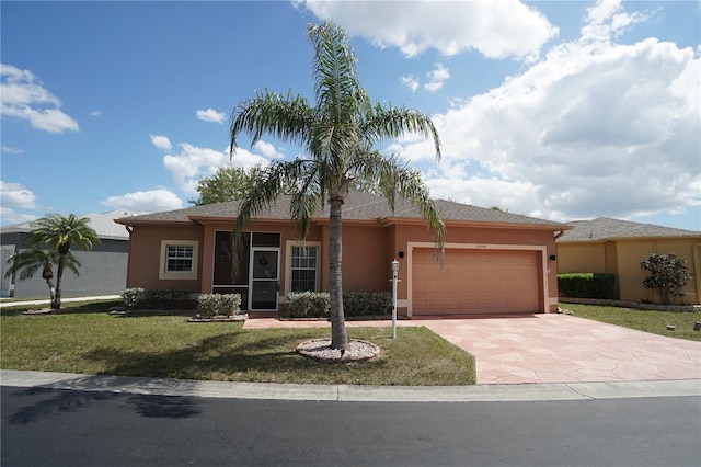 10740 Pearl Bay Cir, Estero, FL 33928 - single story home featuring a garage, a front lawn, stucco siding, and driveway