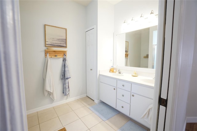 10740 Pearl Bay Cir, Estero, FL 33928 - full bath featuring double vanity, tile patterned floors, baseboards, and a sink