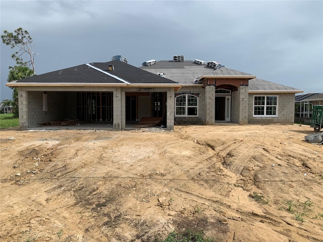 277 Long Meadow Ln, Rotonda West, FL 33947 - rear view of house featuring concrete block siding and a patio