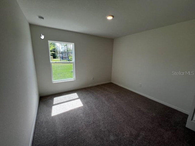 empty room featuring recessed lighting, carpet floors, and baseboards