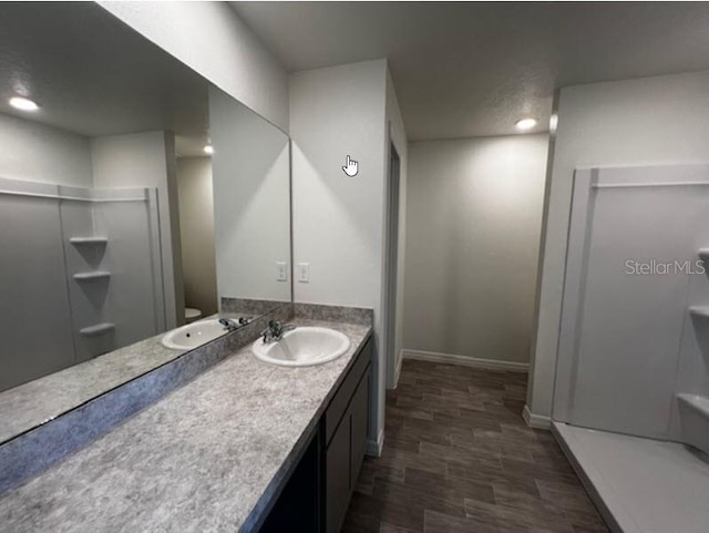 full bath with recessed lighting, a shower stall, vanity, and baseboards