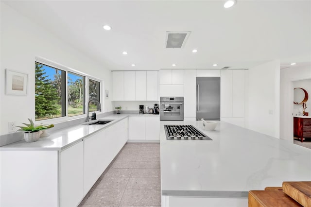 1635 SW Rodgers Ave, Arcadia, FL 34266 - kitchen with modern cabinets, white cabinets, light countertops, a sink, and stainless steel appliances
