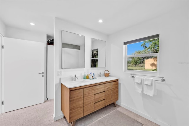 1635 SW Rodgers Ave, Arcadia, FL 34266 - bathroom with double vanity, speckled floor, baseboards, and recessed lighting