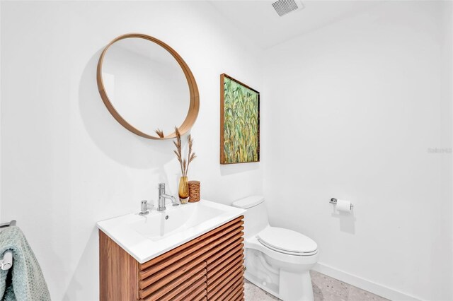 1635 SW Rodgers Ave, Arcadia, FL 34266 - half bathroom featuring toilet, vanity, baseboards, and visible vents