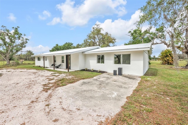 1635 SW Rodgers Ave, Arcadia, FL 34266 - rear view of house with a patio, a yard, and stucco siding